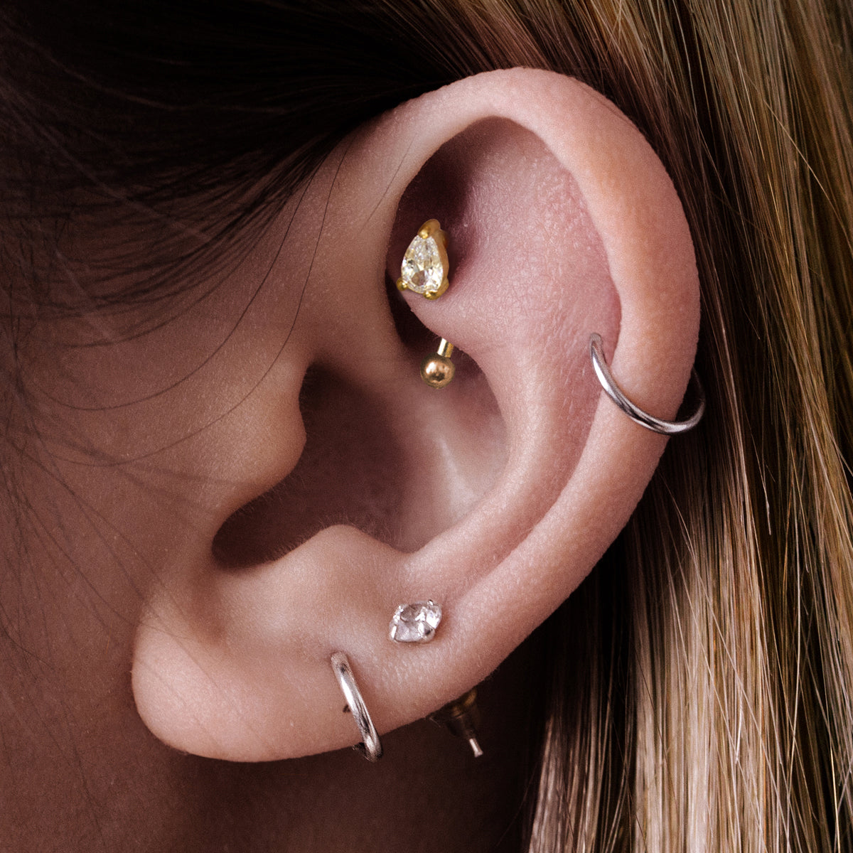 Mania Teardrop Gemstone Rook Curved Barbell Piercing On Model - Gold