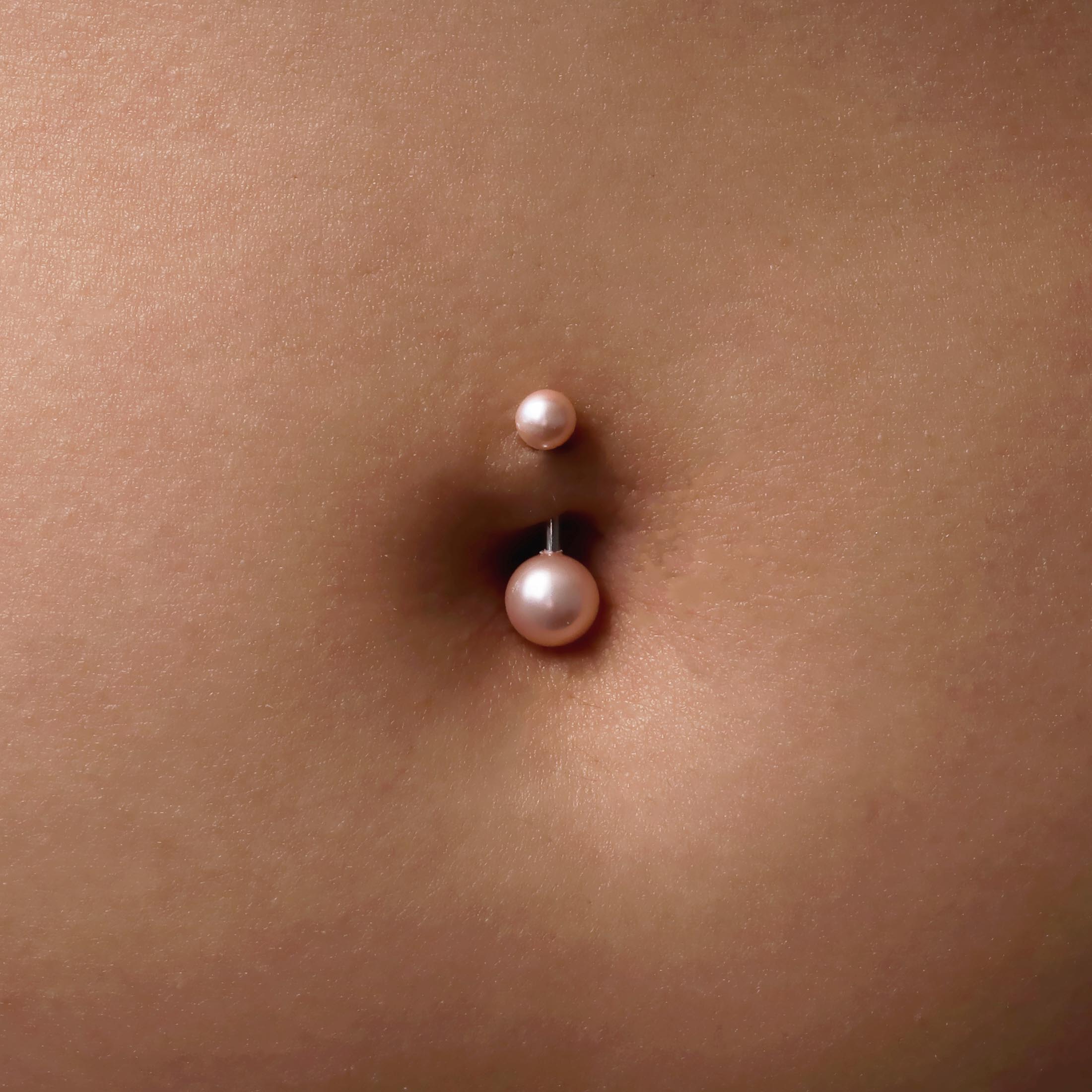 Mira Pearl Belly Bar Piercing On Model - Pink