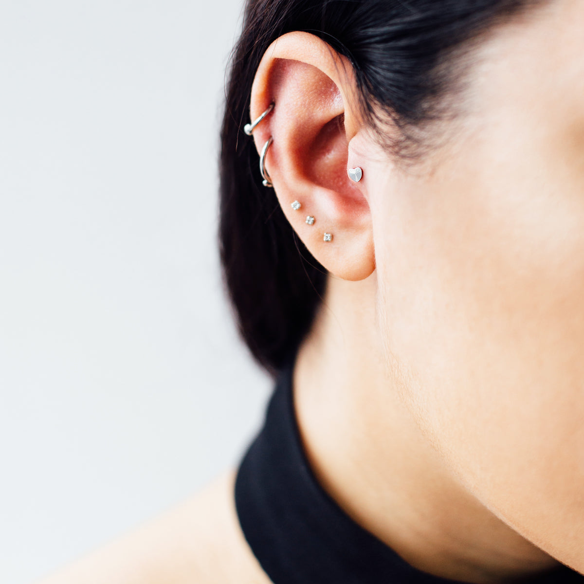 Solid Heart Helix Tragus & Cartilage Ear Piercing On Model - Titanium