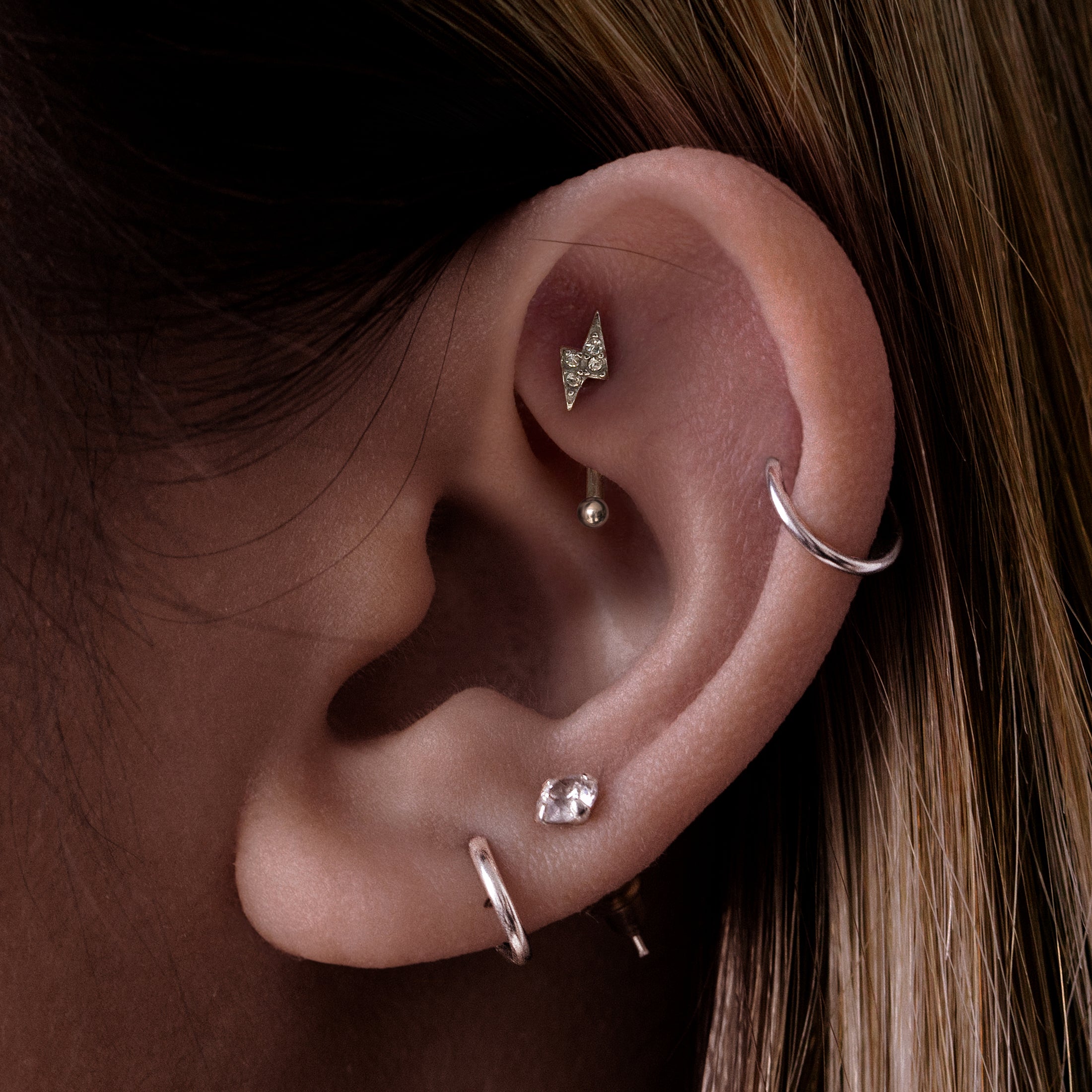 Thunder Bolt Gemstone Rook Curved Barbell Piercing On Model - Silver